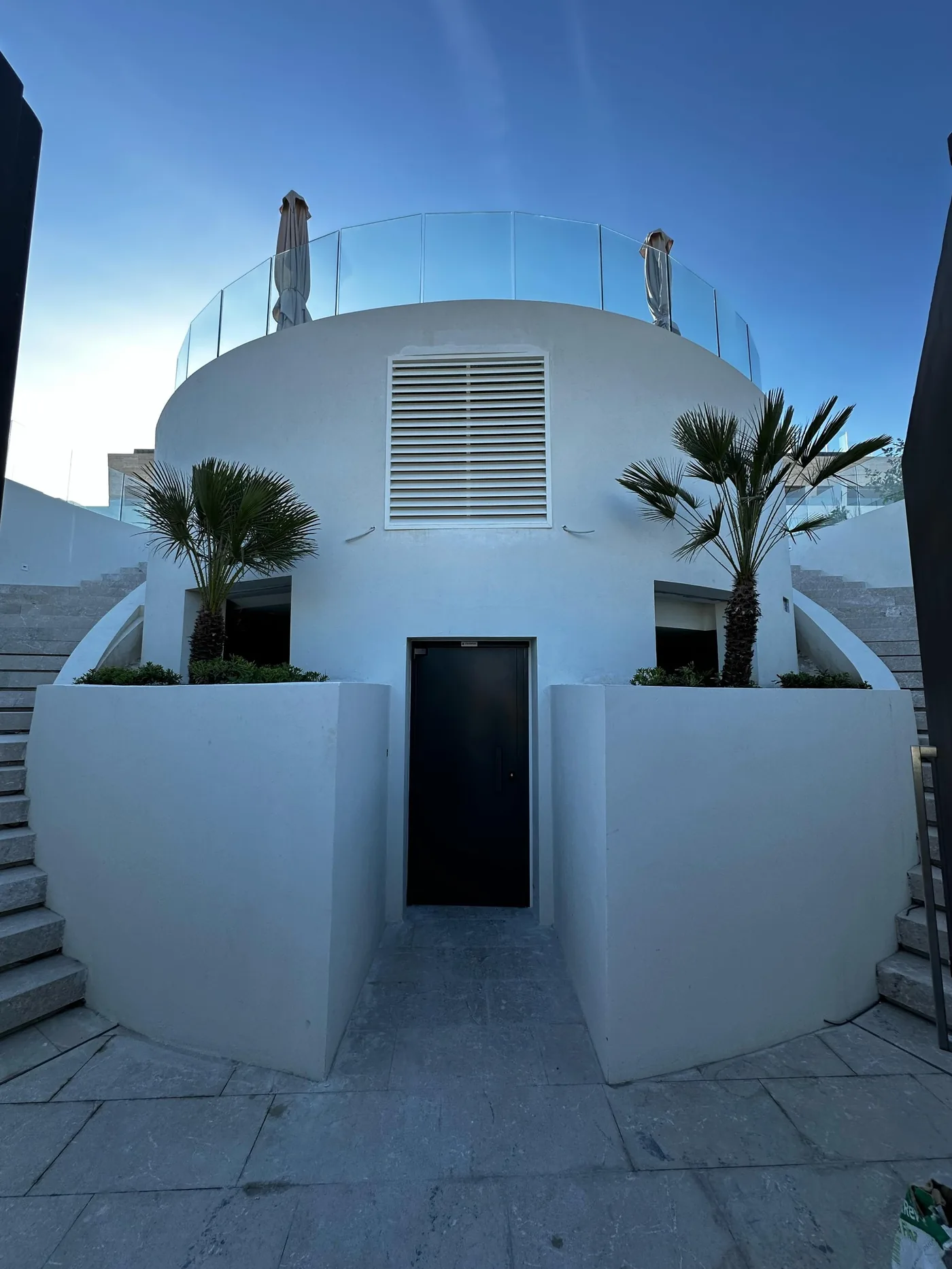 The finished shelter: white dome with ventilation grille and access, built into the terrace.