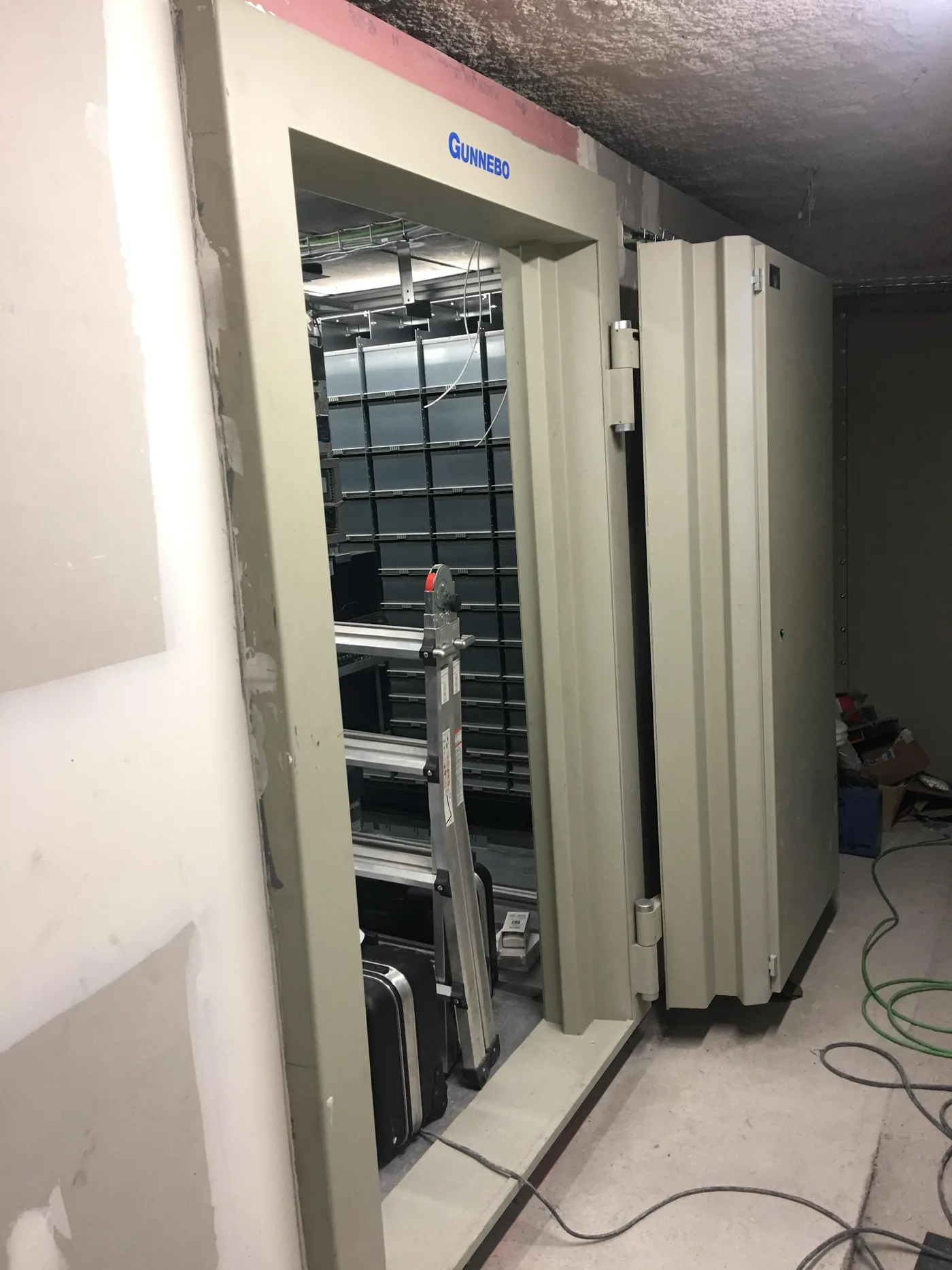 Vault door open during installation, with the compartments behind.